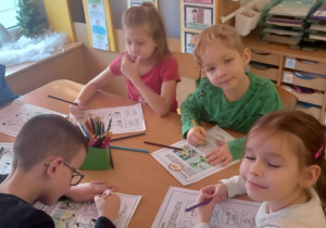 Dzieci uzupełniają karty pracy