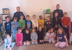 Dzieci pozują do zdjęcia z policjantami