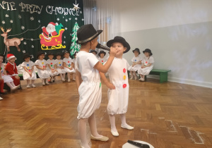Chłopcy odgrywają rolę bałwanków
