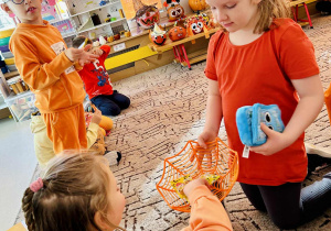 Dziewczynka rozdaje dzieciom żelki