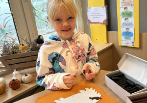 Dziewczynka wykonuje pracę plastyczną