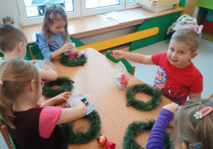 Dzieci ozdabiają świąteczne wianki