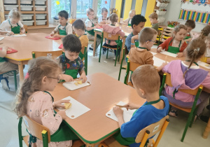dzieci kroją owoce na sok